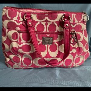Used Pink and silver coach bag. Discoloration on an inside pocket and bottom.